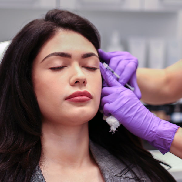 Woman receiving injection at SkinCeuticals Miami clinic