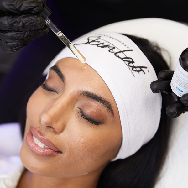 Woman receiving SkinCeuticals facial treatment